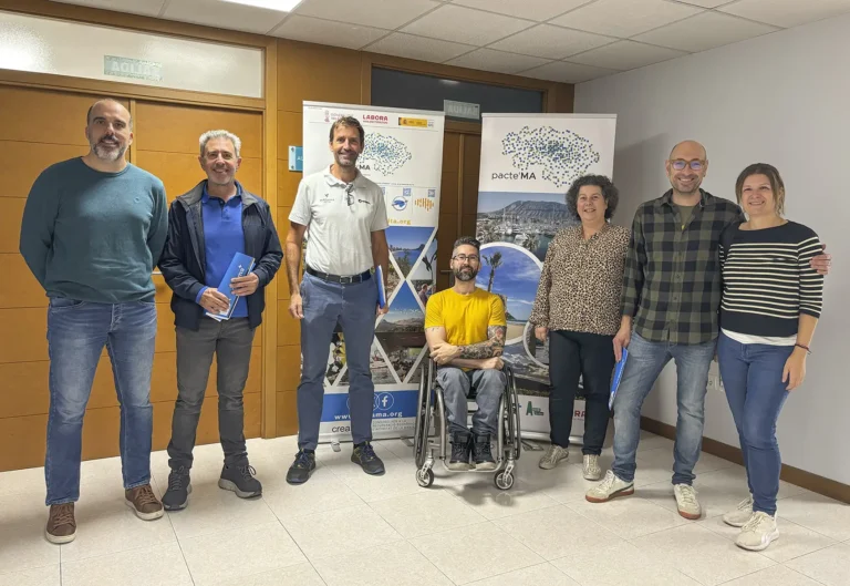 Albert Morell signing the agreement alongside CREAMA representatives and staff from IES Maria Ibars
